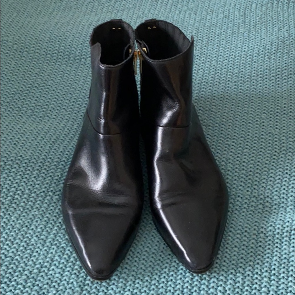 Black leather flat ankle booties.